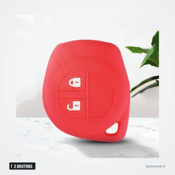 Housse de clé en silicone 2 boutons pour Suzuki Swift, SX4, Vitara, Jimny - housse rouge posée sur un support avec une plante