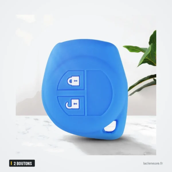 Housse de clé en silicone 2 boutons pour Suzuki Swift, SX4, Vitara, Jimny - housse bleue posée sur un support avec une plante