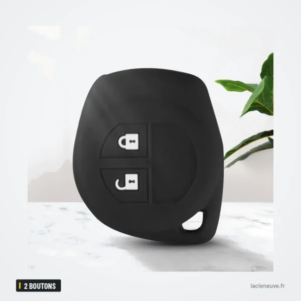 Housse de clé en silicone 2 boutons pour Suzuki Swift, SX4, Vitara, Jimny - housse noire posée sur un support avec une plante
